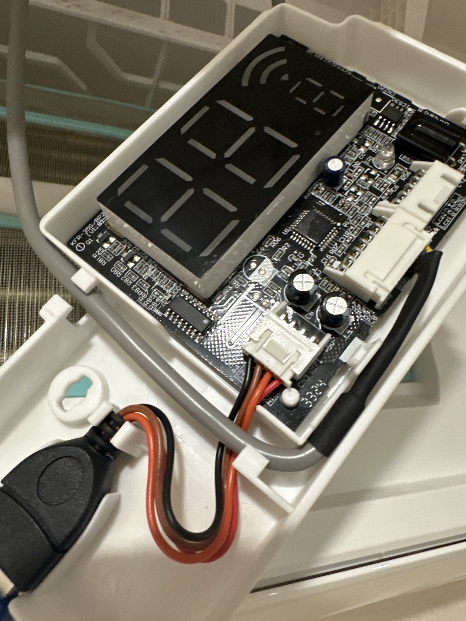 Opened Bosch air-conditioner control board during an ESP32-C3 smart-home integration